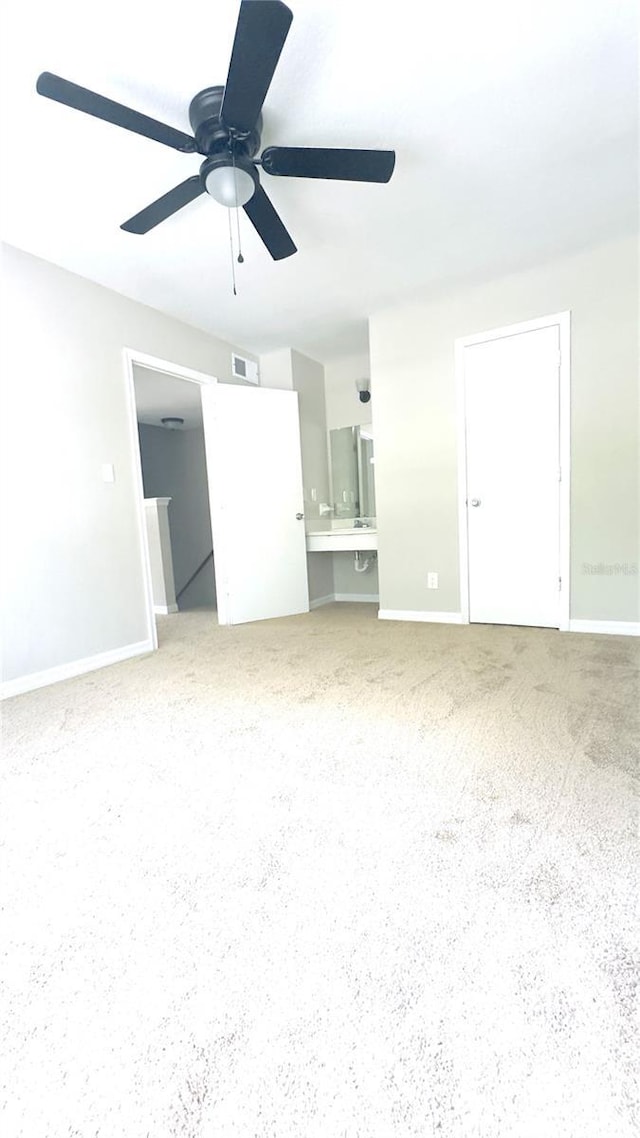 2302 Maki Rd Unit 69, Plant City, FL 33563 - unfurnished living room with ceiling fan, carpet floors, and baseboards