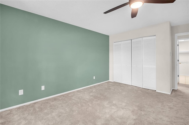 860 Maclaren Dr N Unit A, Palm Harbor, FL 34684 - unfurnished bedroom featuring carpet, a closet, baseboards, and a ceiling fan