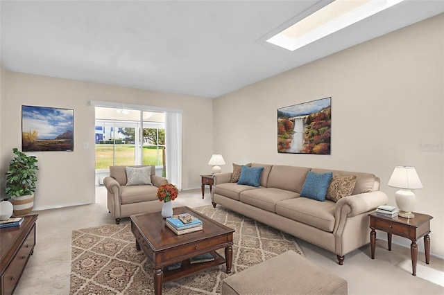 860 Maclaren Dr N Unit A, Palm Harbor, FL 34684 - living room featuring light carpet, a skylight, and baseboards