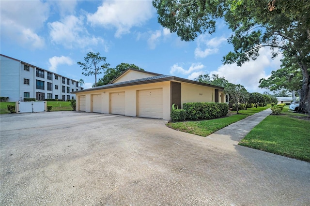 860 Maclaren Dr N Unit A, Palm Harbor, FL 34684 - view of home's exterior featuring stucco siding and a yard