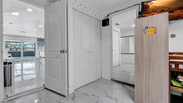 12416 Queensland Ln, Tampa, FL 33625 - hall featuring light marble finish floors, recessed lighting, and baseboards