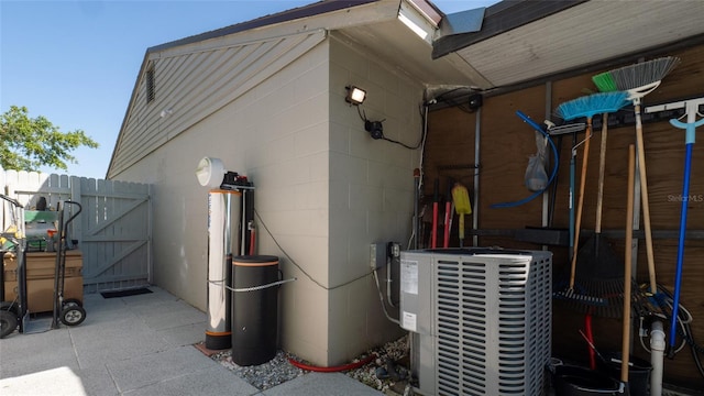 12416 Queensland Ln, Tampa, FL 33625 - view of home's exterior featuring a gate, central AC unit, and concrete block siding