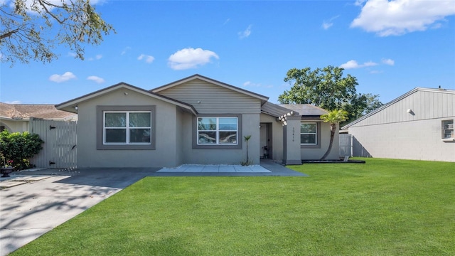 12416 Queensland Ln, Tampa, FL 33625 - rear view of property with a gate, stucco siding, a patio, and solar panels