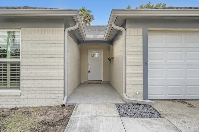 3058 Cara Ct, Palm Harbor, FL 34684 - entrance to property with stucco siding, an attached garage, and brick siding
