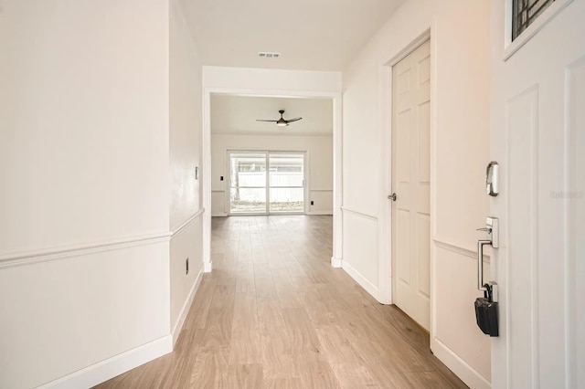 3058 Cara Ct, Palm Harbor, FL 34684 - corridor with light wood finished floors and baseboards