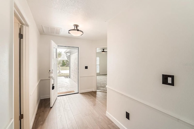 3058 Cara Ct, Palm Harbor, FL 34684 - doorway to outside with baseboards, light wood-style flooring, and ceiling fan