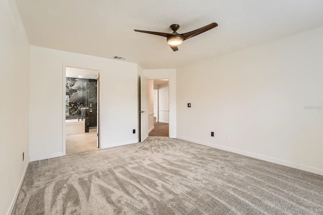 3058 Cara Ct, Palm Harbor, FL 34684 - unfurnished bedroom with carpet floors, baseboards, connected bathroom, and ceiling fan