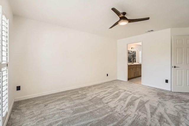 3058 Cara Ct, Palm Harbor, FL 34684 - unfurnished bedroom featuring light carpet, baseboards, ensuite bath, and a ceiling fan