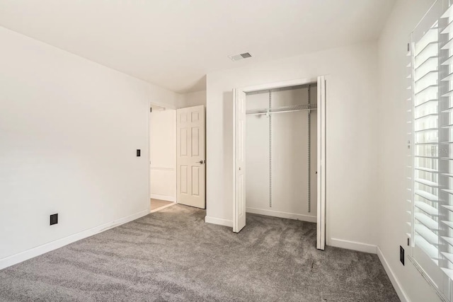 3058 Cara Ct, Palm Harbor, FL 34684 - unfurnished bedroom with carpet flooring, a closet, and baseboards
