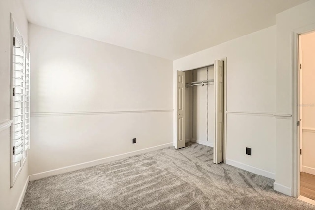 3058 Cara Ct, Palm Harbor, FL 34684 - unfurnished bedroom featuring carpet flooring, a closet, and baseboards