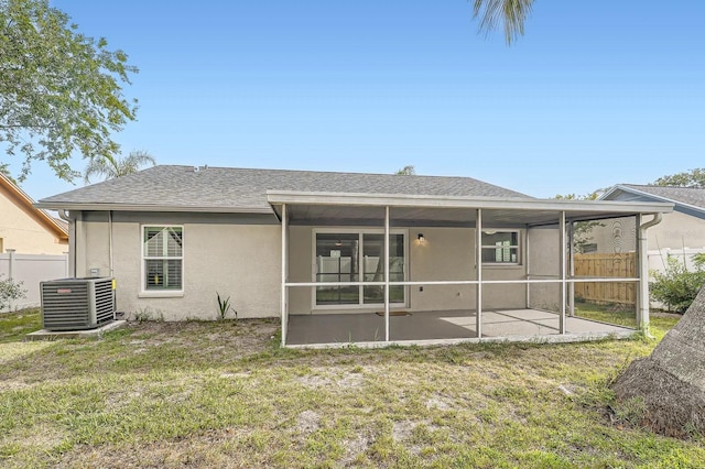 3058 Cara Ct, Palm Harbor, FL 34684 - back of property with central AC unit, a patio, a sunroom, and stucco siding