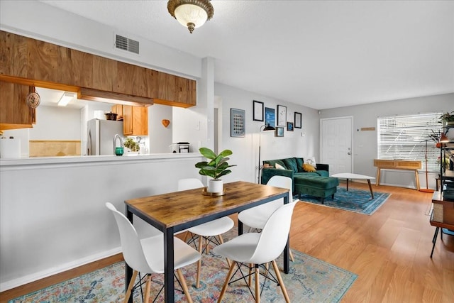 4004 Dream Oak Pl Unit 102, Tampa, FL 33613 - dining area with light wood-style flooring and baseboards