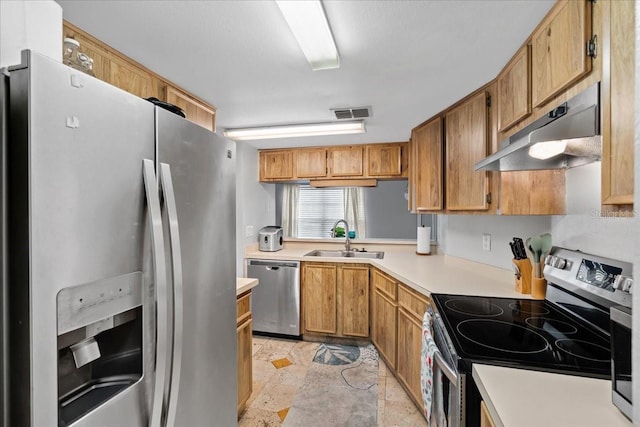 4004 Dream Oak Pl Unit 102, Tampa, FL 33613 - kitchen with stainless steel appliances, a sink, under cabinet range hood, light countertops, and light stone finish floors