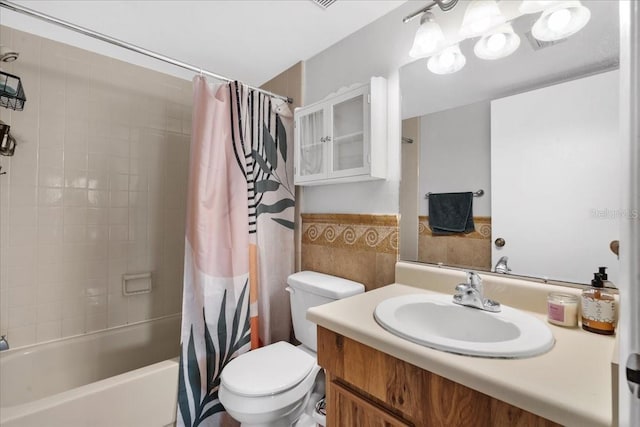 4004 Dream Oak Pl Unit 102, Tampa, FL 33613 - full bathroom with tile walls, toilet, shower / bath combo with shower curtain, vanity, and wainscoting