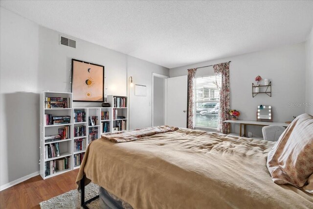 4004 Dream Oak Pl Unit 102, Tampa, FL 33613 - bedroom with wood finished floors, a textured ceiling, and baseboards