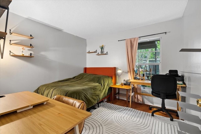 4004 Dream Oak Pl Unit 102, Tampa, FL 33613 - bedroom with an office area, wood finished floors, and a textured ceiling