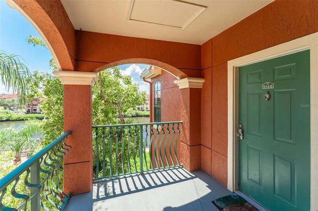 2741 Via Cipriani Unit 934B, Clearwater, FL 33764 - doorway to property featuring a balcony, a water view, and stucco siding