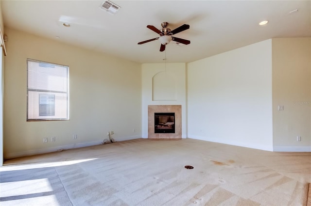 1531 Ember Ln, Tarpon Springs, FL 34689 - unfurnished living room featuring light colored carpet, a tile fireplace, ceiling fan, baseboards, and recessed lighting
