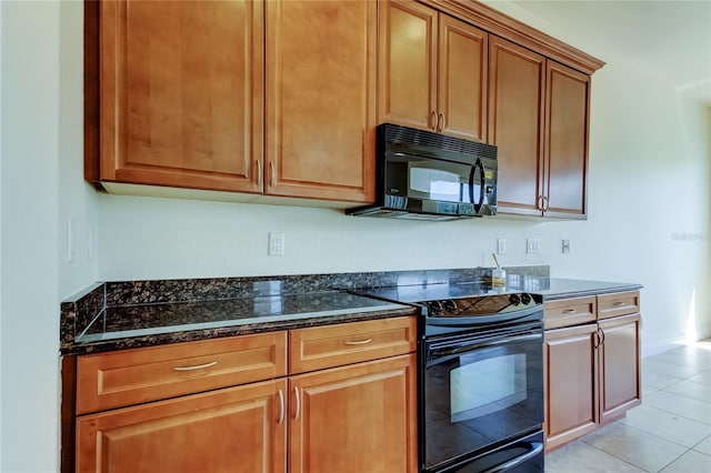 1531 Ember Ln, Tarpon Springs, FL 34689 - kitchen with black appliances, dark stone countertops, light tile patterned floors, and brown cabinetry