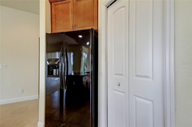 1531 Ember Ln, Tarpon Springs, FL 34689 - kitchen featuring black fridge, baseboards, light colored carpet, and brown cabinets