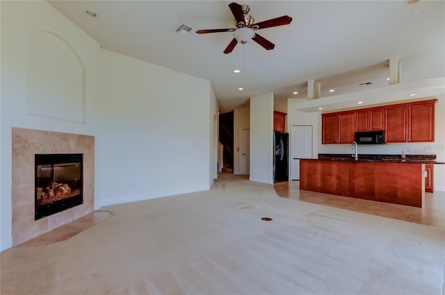 1531 Ember Ln, Tarpon Springs, FL 34689 - unfurnished living room featuring ceiling fan, light colored carpet, a sink, a tile fireplace, and recessed lighting