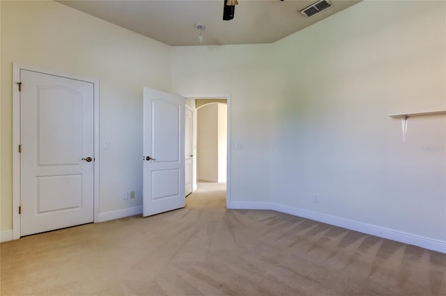 1531 Ember Ln, Tarpon Springs, FL 34689 - unfurnished bedroom featuring light colored carpet, baseboards, and a ceiling fan