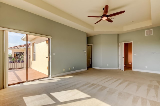 1531 Ember Ln, Tarpon Springs, FL 34689 - spare room featuring a raised ceiling, ceiling fan, light carpet, and baseboards