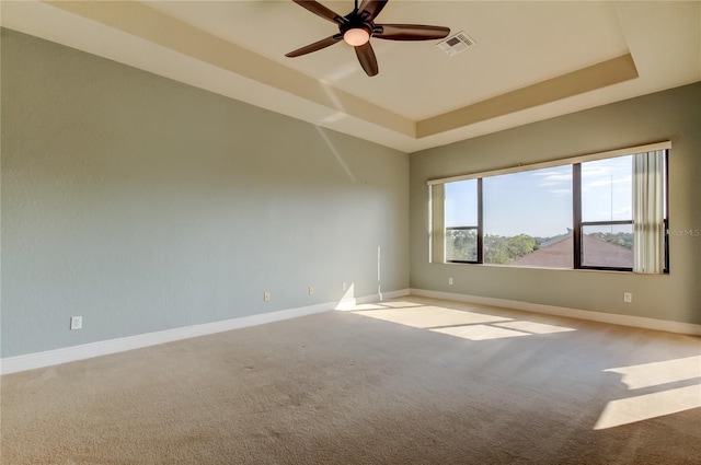 1531 Ember Ln, Tarpon Springs, FL 34689 - carpeted spare room featuring a raised ceiling, a ceiling fan, and baseboards