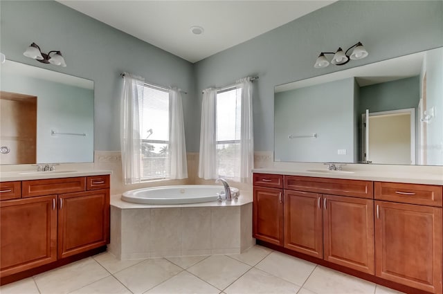 1531 Ember Ln, Tarpon Springs, FL 34689 - full bathroom featuring two vanities, a garden tub, and tile patterned flooring