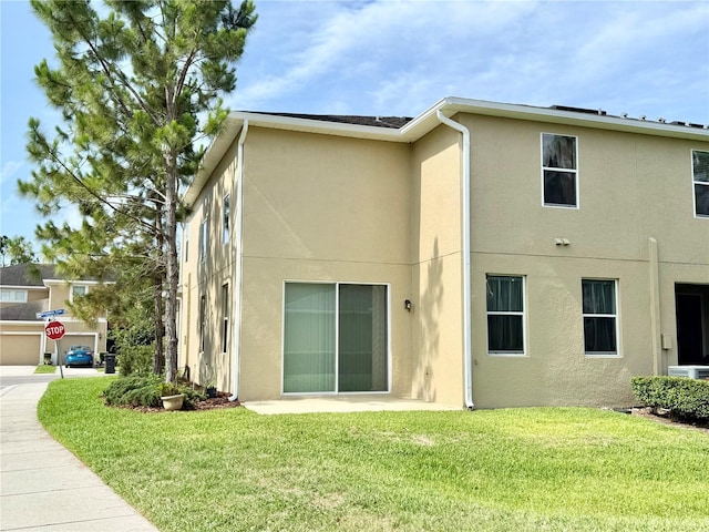 2130 Broadway View Ave, Brandon, FL 33510 - back of property featuring stucco siding and a lawn