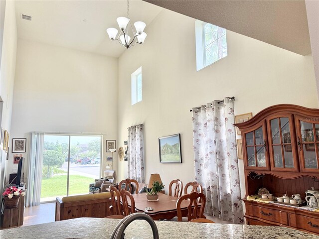 2130 Broadway View Ave, Brandon, FL 33510 - dining room with high vaulted ceiling, a chandelier, and wood finished floors