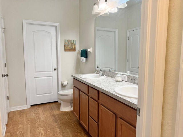 2130 Broadway View Ave, Brandon, FL 33510 - full bath with double vanity, wood finished floors, toilet, and a chandelier