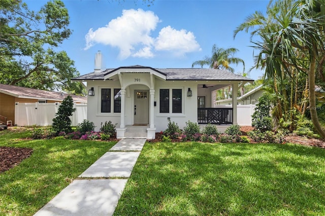 791 44th Ave N, Saint Petersburg, FL 33703 - view of front facade with covered porch, stucco siding, and a chimney