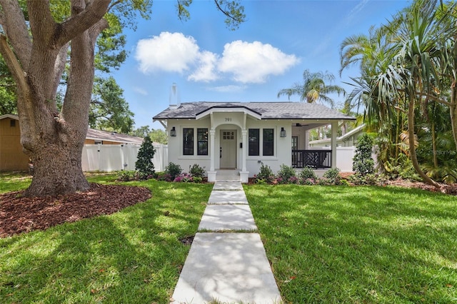791 44th Ave N, Saint Petersburg, FL 33703 - view of front of home with covered porch, stucco siding, and roof with shingles