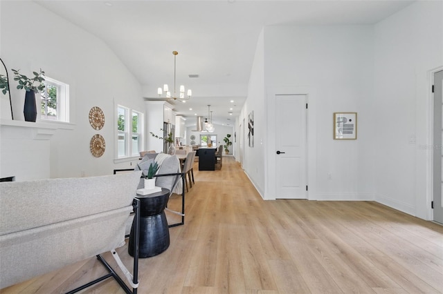 791 44th Ave N, Saint Petersburg, FL 33703 - entryway with light wood-type flooring, a chandelier, and baseboards