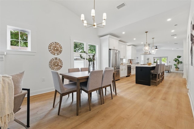 791 44th Ave N, Saint Petersburg, FL 33703 - dining area featuring a chandelier, recessed lighting, light wood-style flooring, baseboards, and lofted ceiling