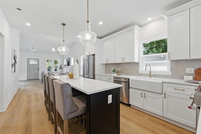 791 44th Ave N, Saint Petersburg, FL 33703 - kitchen with high quality appliances, a kitchen island, tasteful backsplash, white cabinetry, and recessed lighting