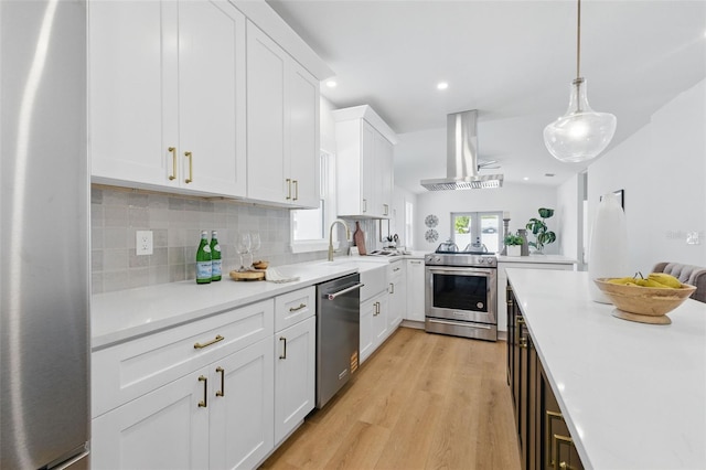 791 44th Ave N, Saint Petersburg, FL 33703 - kitchen featuring stainless steel appliances, range hood, light countertops, light wood-style flooring, and recessed lighting