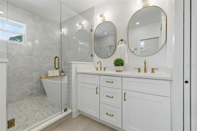 791 44th Ave N, Saint Petersburg, FL 33703 - full bath featuring double vanity, tile patterned flooring, a shower stall, and a freestanding tub