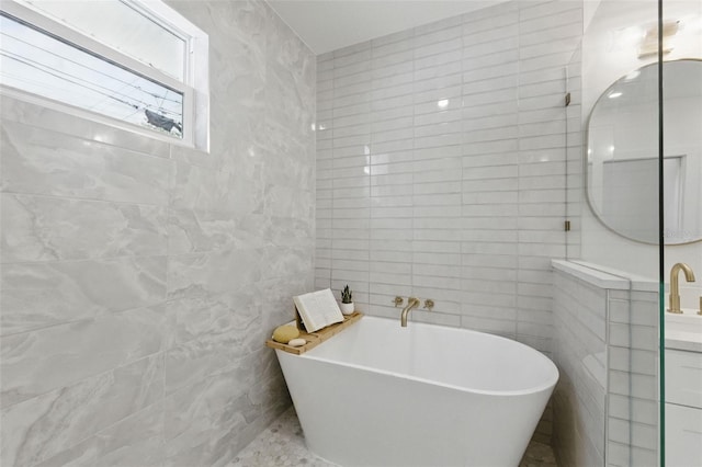 791 44th Ave N, Saint Petersburg, FL 33703 - bathroom featuring tile walls, a freestanding bath, and vanity