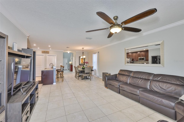 6512 Trent Creek Dr, Sun City Center, FL 33573 - living area featuring crown molding, light tile patterned floors, a ceiling fan, and baseboards