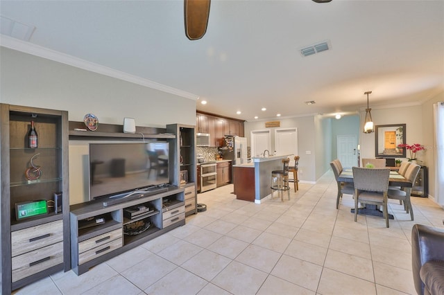 6512 Trent Creek Dr, Sun City Center, FL 33573 - living room with ornamental molding, light tile patterned flooring, recessed lighting, and baseboards