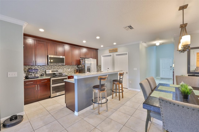 6512 Trent Creek Dr, Sun City Center, FL 33573 - kitchen with appliances with stainless steel finishes, crown molding, a kitchen bar, tasteful backsplash, and light tile patterned floors