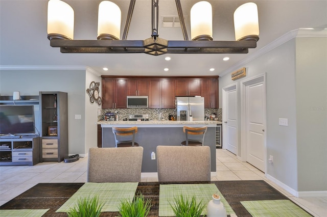 6512 Trent Creek Dr, Sun City Center, FL 33573 - kitchen with stainless steel appliances, light tile patterned floors, decorative backsplash, ornamental molding, and recessed lighting
