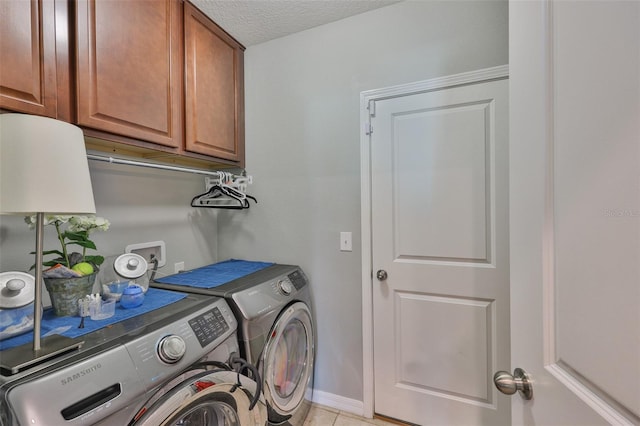 6512 Trent Creek Dr, Sun City Center, FL 33573 - laundry area featuring washer and dryer, cabinet space, baseboards, a textured ceiling, and light tile patterned floors