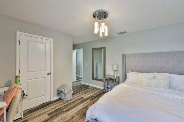 6512 Trent Creek Dr, Sun City Center, FL 33573 - bedroom featuring wood finished floors, a chandelier, and baseboards