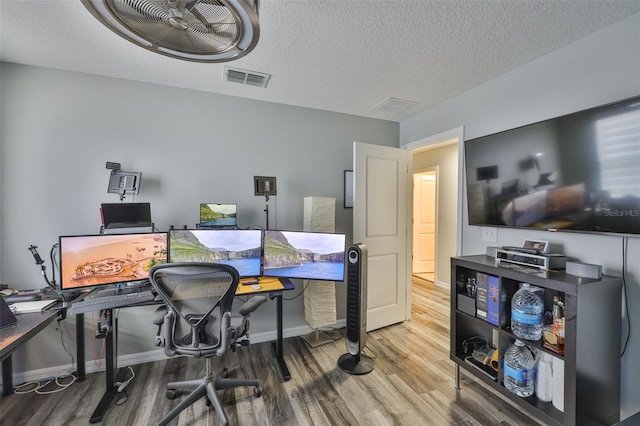 6512 Trent Creek Dr, Sun City Center, FL 33573 - office featuring wood finished floors, baseboards, and a textured ceiling