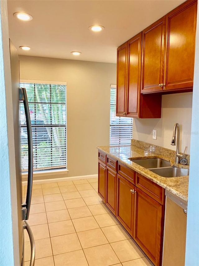 1515 Bayshore Blvd Unit 38, Dunedin, FL 34698 - kitchen with healthy amount of natural light, dishwasher, light tile patterned floors, brown cabinets, and recessed lighting