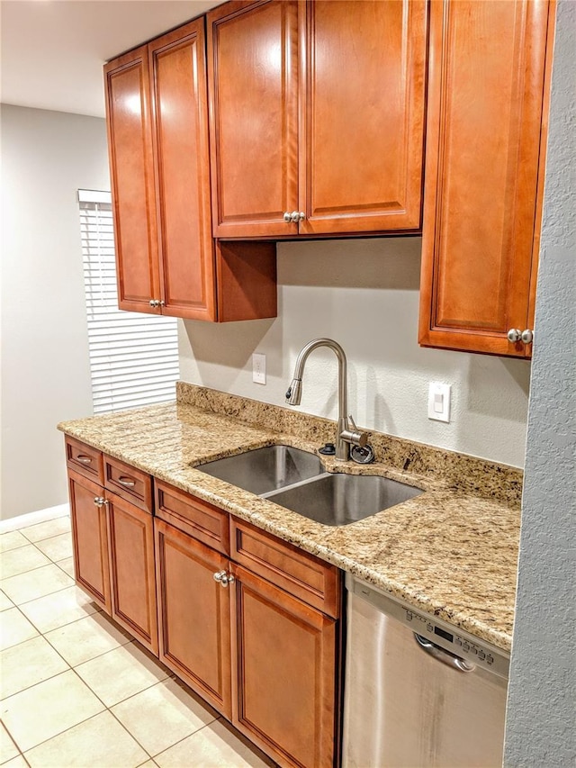 1515 Bayshore Blvd Unit 38, Dunedin, FL 34698 - kitchen with stainless steel dishwasher, light tile patterned floors, light stone countertops, and brown cabinetry