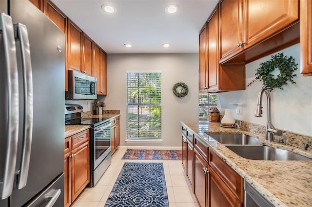 1515 Bayshore Blvd Unit 38, Dunedin, FL 34698 - kitchen featuring stainless steel appliances, recessed lighting, light stone countertops, brown cabinetry, and light tile patterned floors